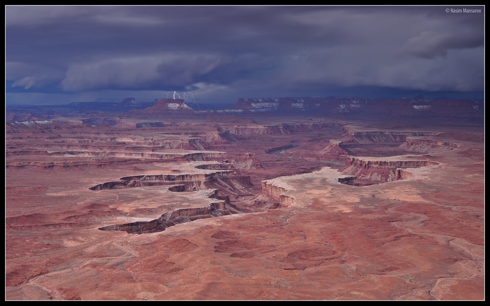 A photograph of lightning with Green River in the foreground