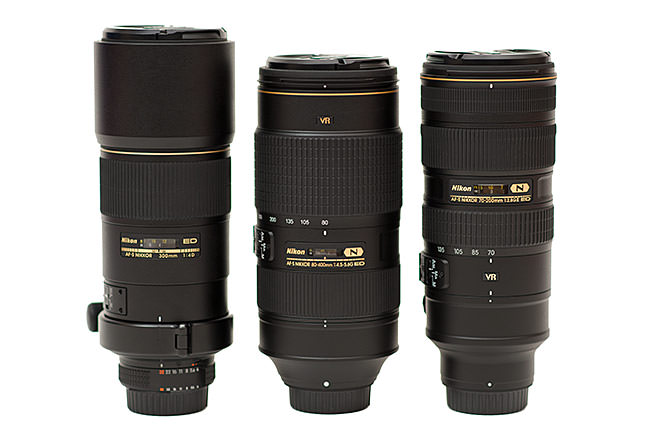 Three DSLR telephoto lenses side by side - the Nikon 300mm f/4D, Nikon 80-400mm, and Nikon 70-200mm