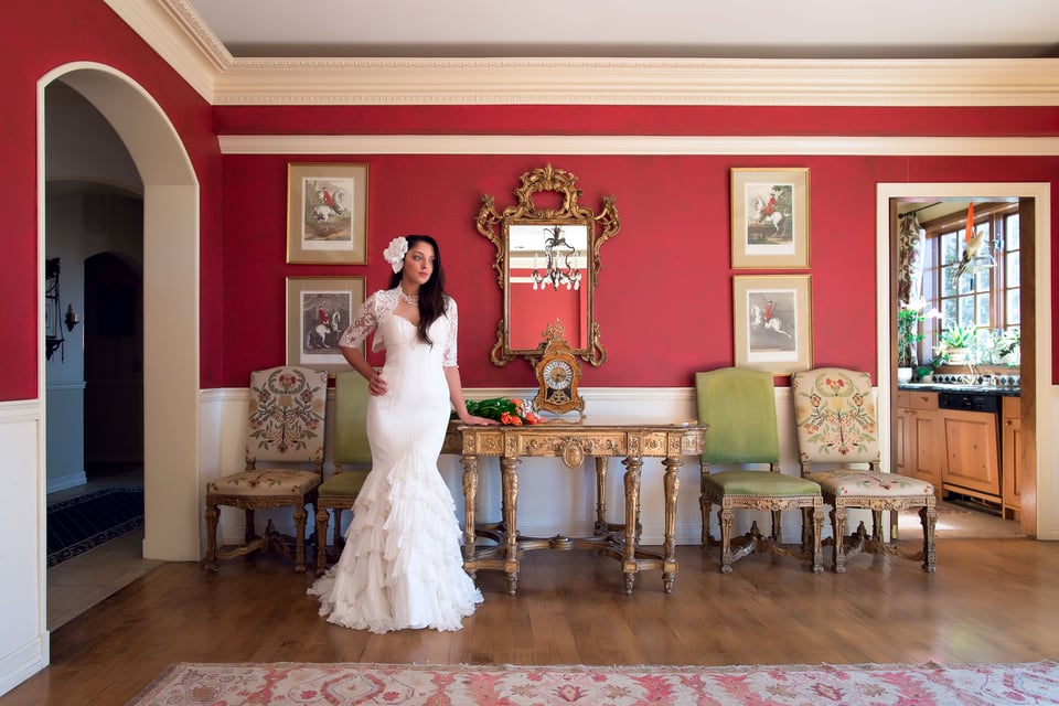 An environmental portrait of a bride in a beautifully-designed room, captured with a 20mm f/1.8 ultra-wide angle lens