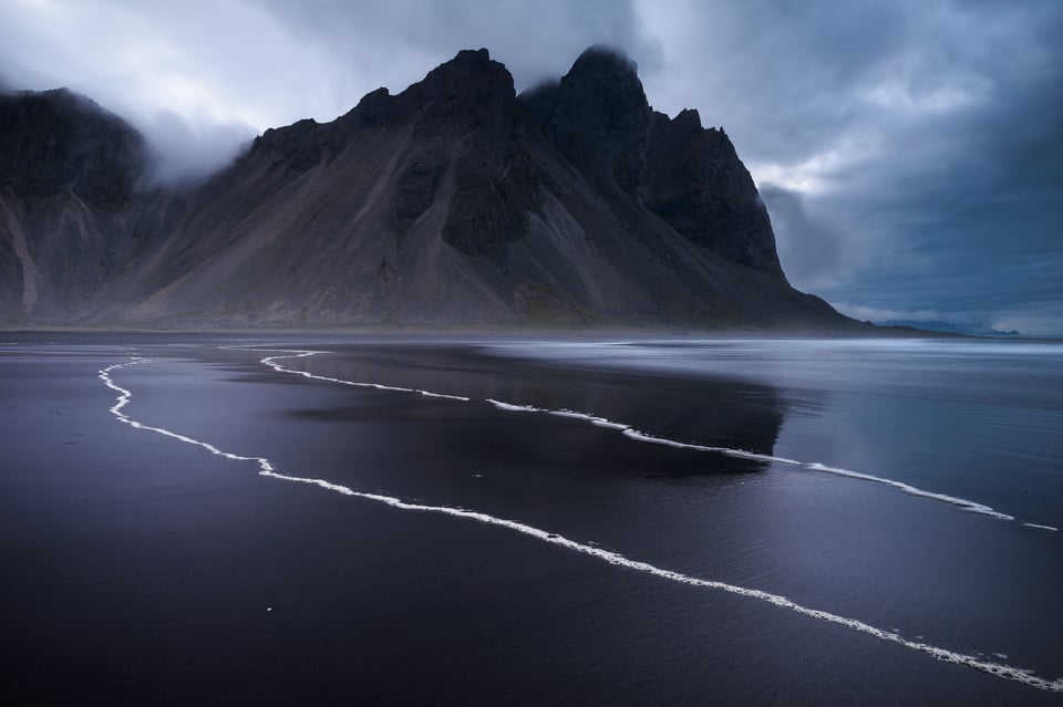 This landscape photo is so intense because of the dark blue lighting and high contrast.