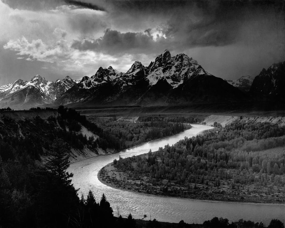 Ansel Adams is perhaps the most famous photographer of all time. This public domain landscape photo shows the Snake River in front of the Grand Teton mountain range.