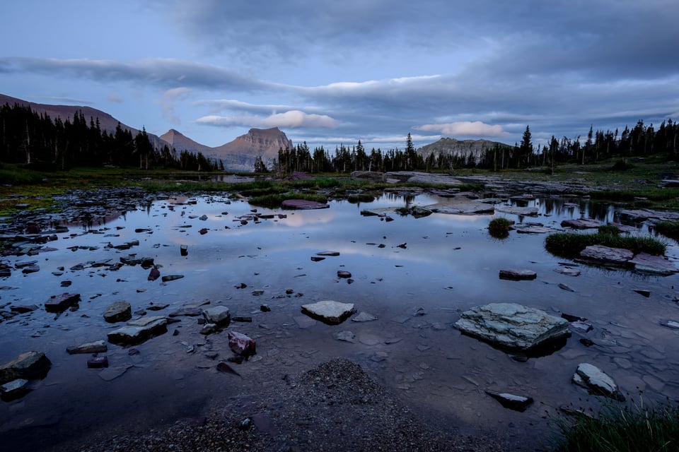 This landscape photo from Glacier National Park demonstrates the ideal camera settings for blue hour photography. Here, I needed an 8-second exposure, which is why you should use a tripod for taking pictures before sunrise.