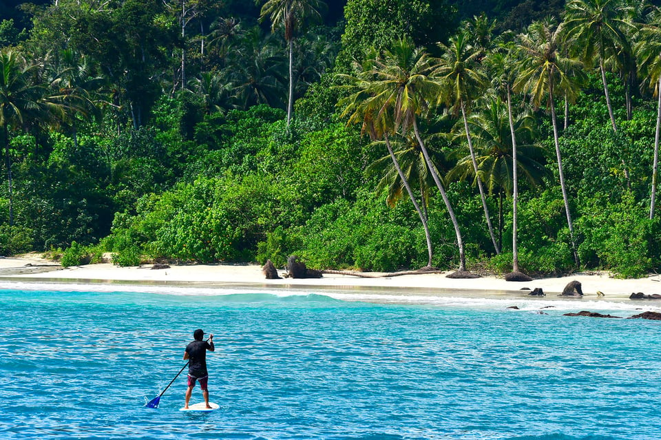 Surfer in blue waters