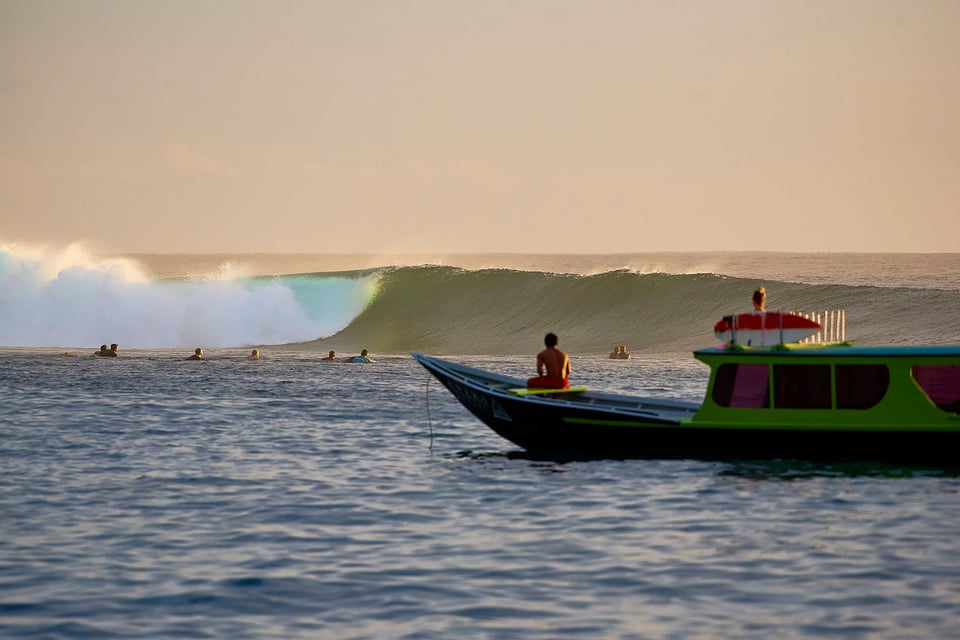 Surfers moving towards waves