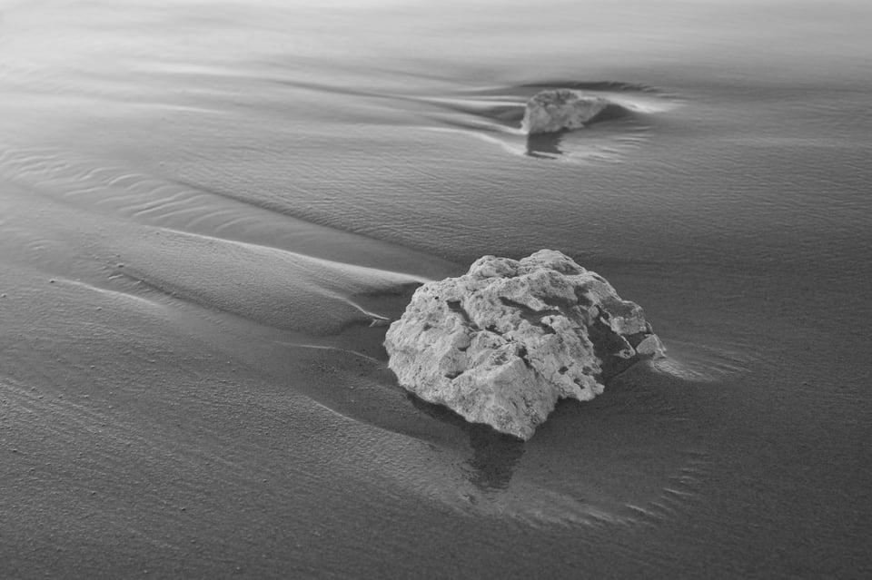 Rocks in the Sand Near the Lake