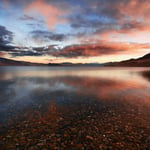 A reflection of a lake at sunset with colorful clouds - how to capture reflection photographs