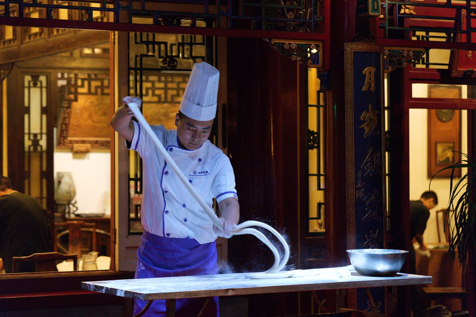 This photo shows a chef making noodles by hand. I took it at ISO 12,800 because it was so dark, but the photo is still completely sharp.