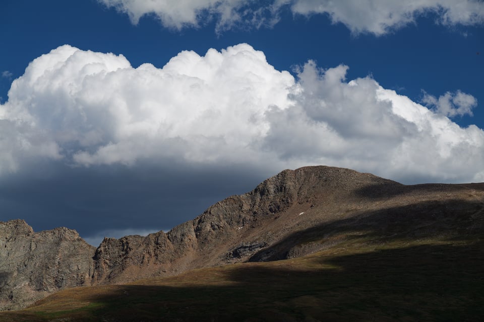 This landscape photo shows a cloud over Mount Evans in Colorado.