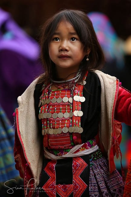 A ‘Flower Hmong’ girl at a mountain market in northern Vietnam. The mountains of Vietnam are among the last areas of Southeast Asia where traditional dress is still commonly worn among numerous different tribes. Many of them (not the Hmong) are considered ‘vanishing’.