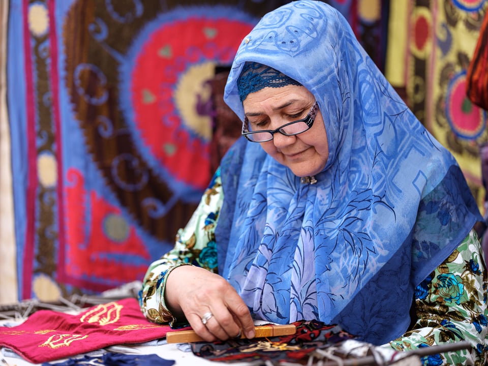 A female dressmaker working on traditional Uzbek clothes