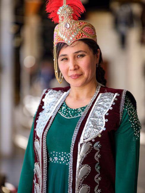A portrait of a young woman wearing traditional Uzbek dress