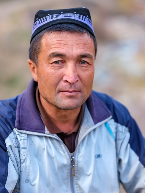 A close-up portrait of an Uzbek man
