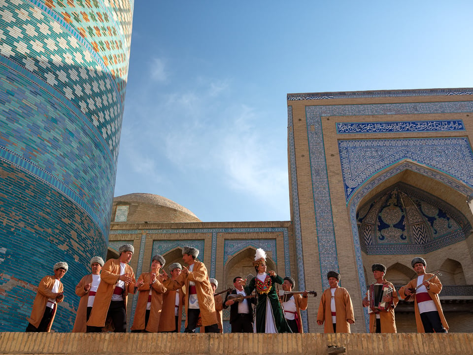 A group of performers singing and dancing in Khiva
