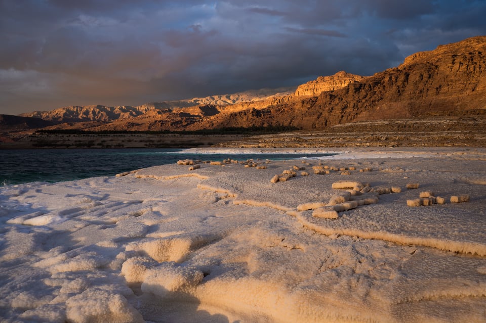 Dead Sea Jordan salt formations with dramatic light at sunset