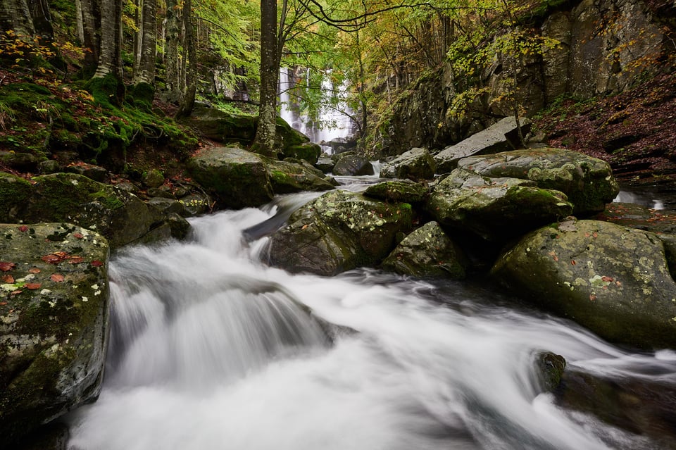 The water flows quickly between the rocks