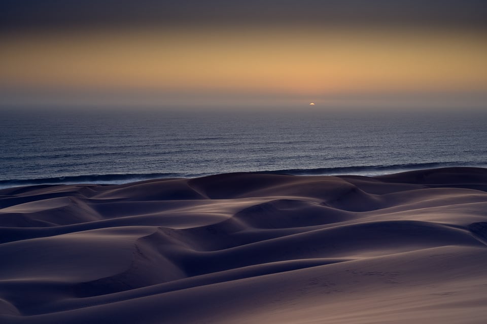 Dunes and ocean at sunset