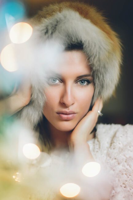 An image of a female model with blurred foreground lights - what is aperture