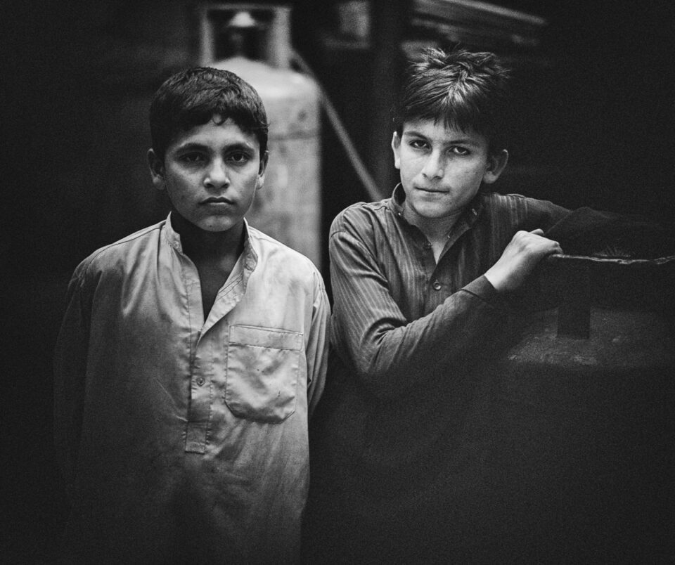 Young boys who work as waiters at a local chai khana (tea house) that services the working class.
