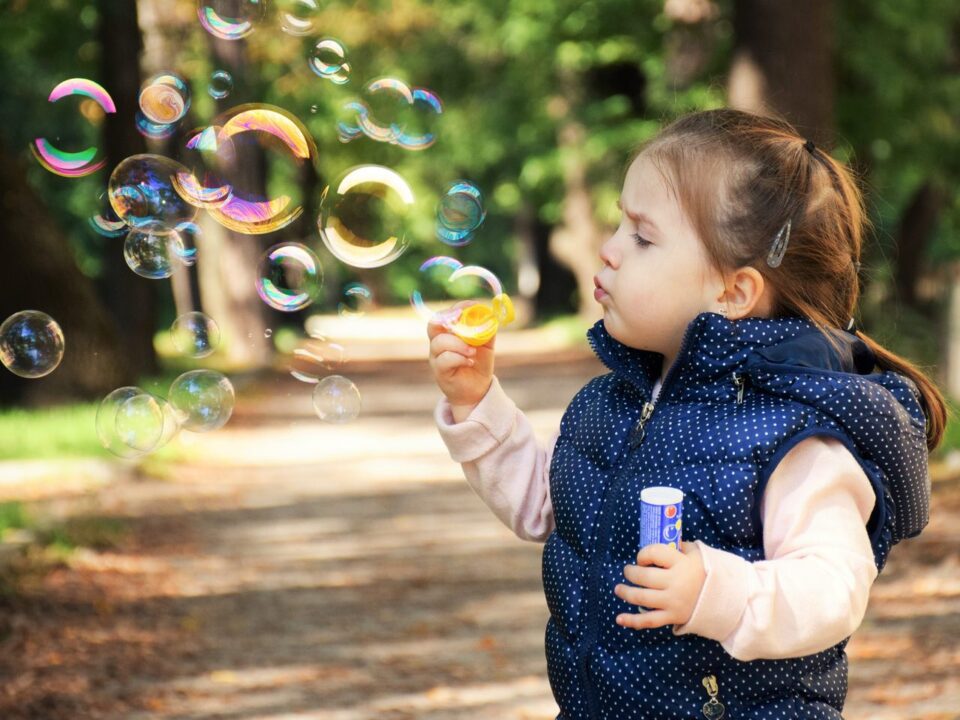 Little Girl Playing Soap Bubbles