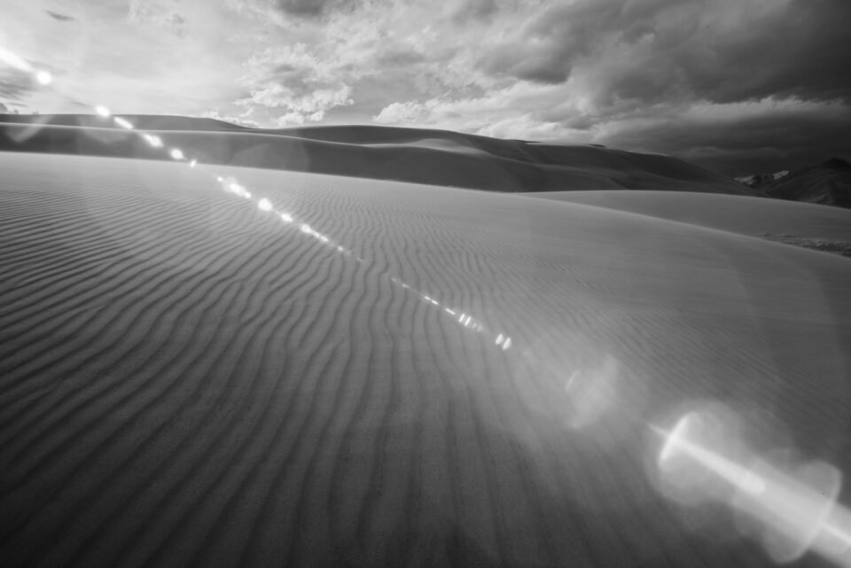 This black and white landscape photo has extremely high levels of lens flare.