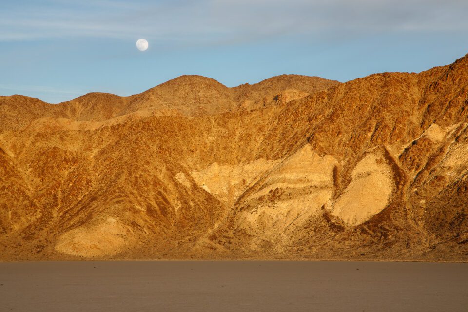 Image of the moon over mountains at sunset - how to photograph the moon