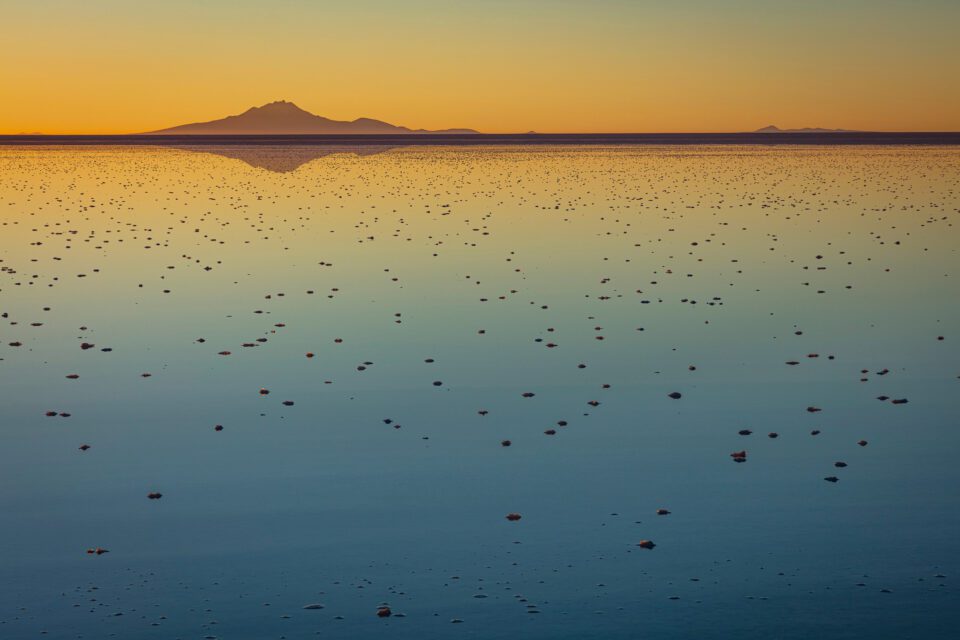 Salar de Uyuni is one of the most famous and beautiful areas of Bolivia for landscape photography. Here, sunset reflects colors in a flooded lake.