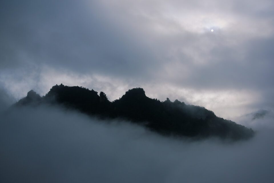 In this Nikon D3500 sample photo, the landscape at Zhangjiajie in China is illuminated at sunrise on a foggy day.