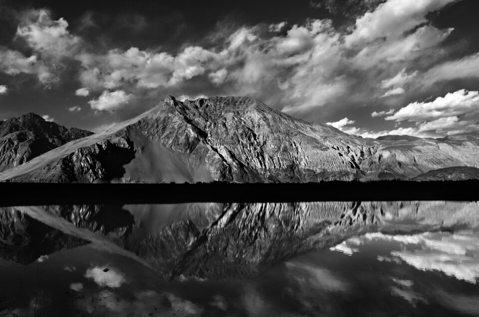 A black and white image of a lake reflection - how to take better reflection pictures