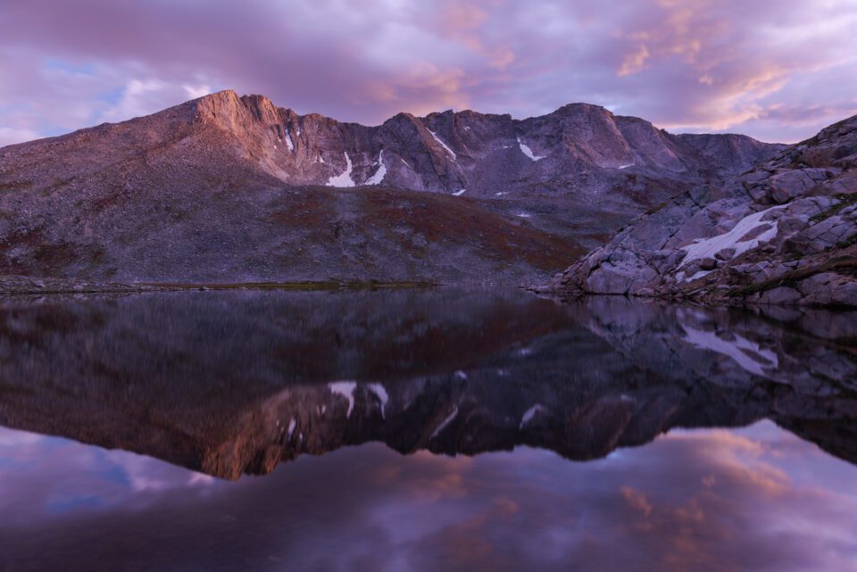 A landscape photo at sunset of Summit Lake, Mount Evans, Colorado.
