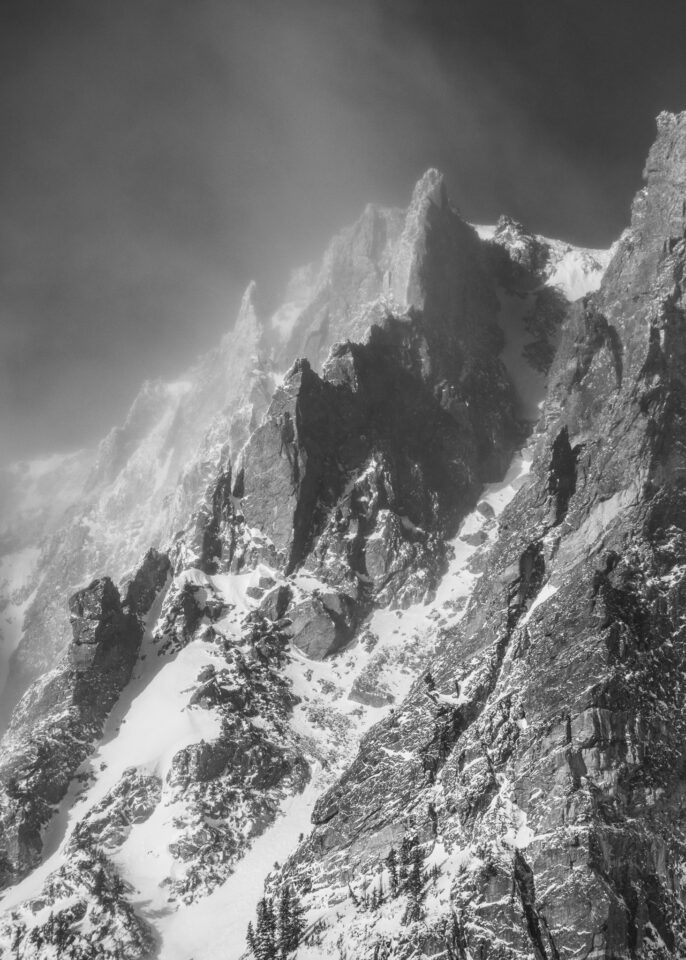 This is a harsh black and white photograph of a winter landscape. The jagged edges of the mountain match well with the intensity of the cold weather conditions.