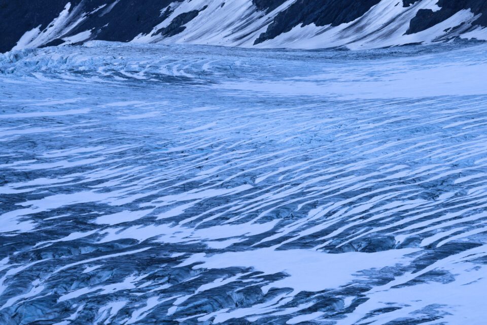 This abstract photo shows the patterns of lines on a glacier.