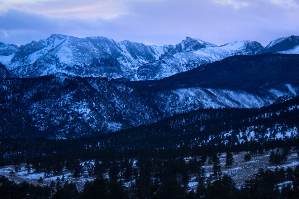 This landscape photo shows Rocky Mountain National Park in the snow during winter.