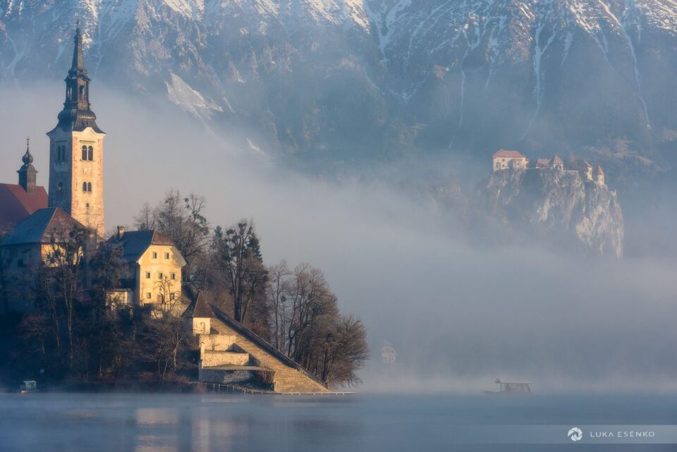 First visitors arriving at Lake Bled island, photographed from the "bench"