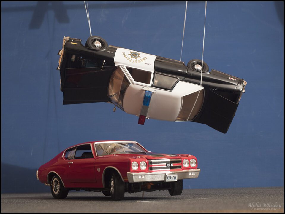 Police car model suspended with wires