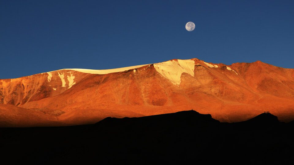 Golden hues of the mountain set against a blue sky brings color contrast to the picture