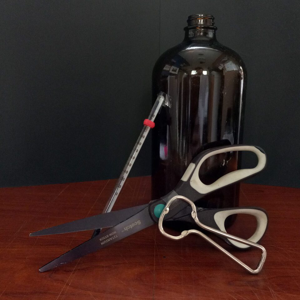 Scissors, can opener, thermometer, and glass amber bottle